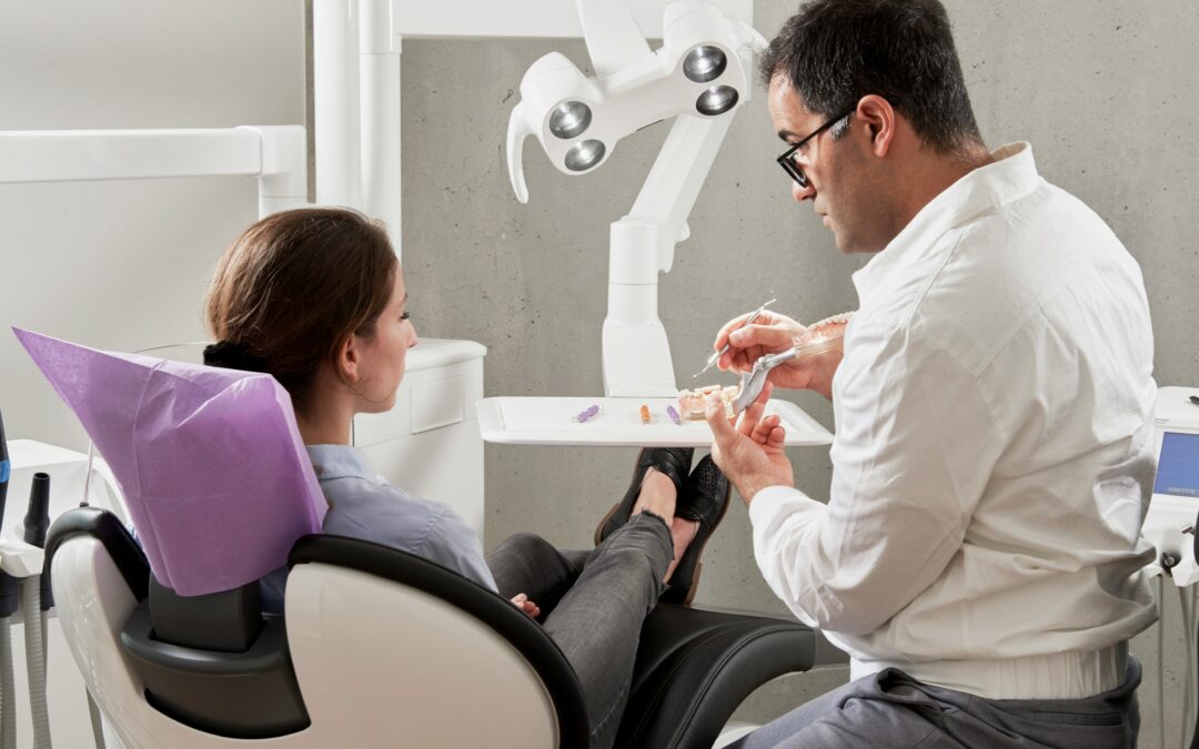 Dentist reviewing dental restoration and bite with a patient